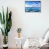 Painting of seascape hanging in a room