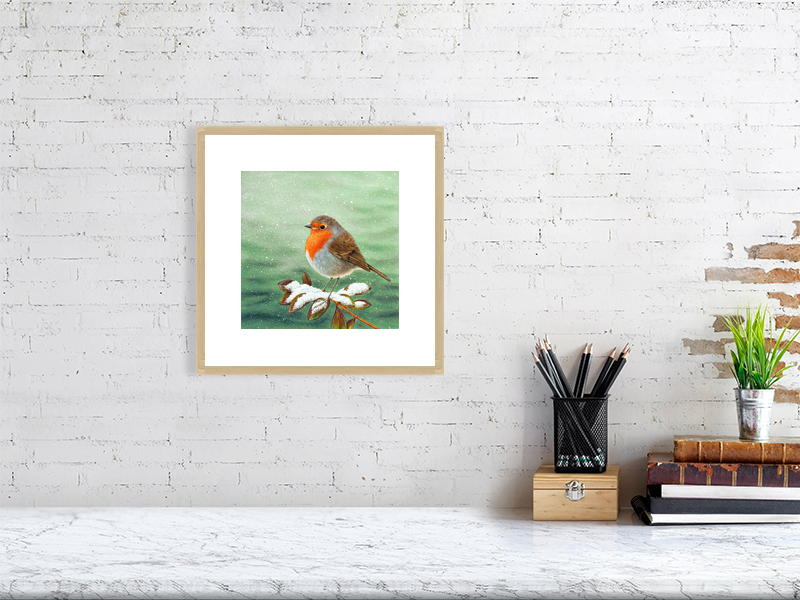 Print of a robin in an oak picture frame and white mount