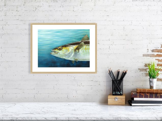 Pollock fish print in an oak frame hanging on a wall.